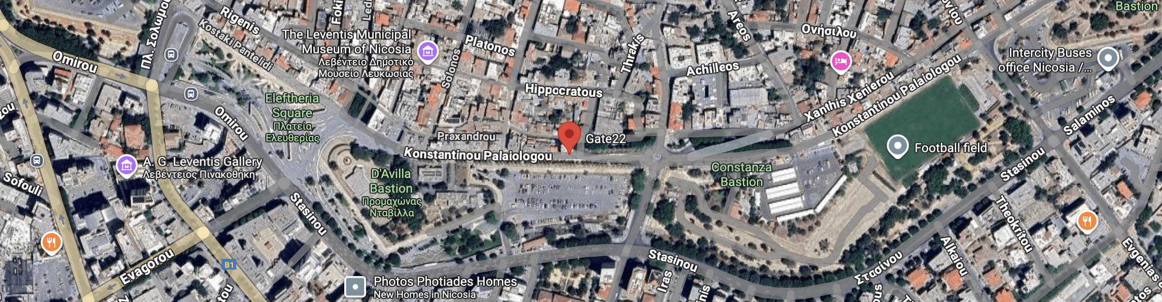 Aerial view of a busy urban intersection with labeled streets and buildings.