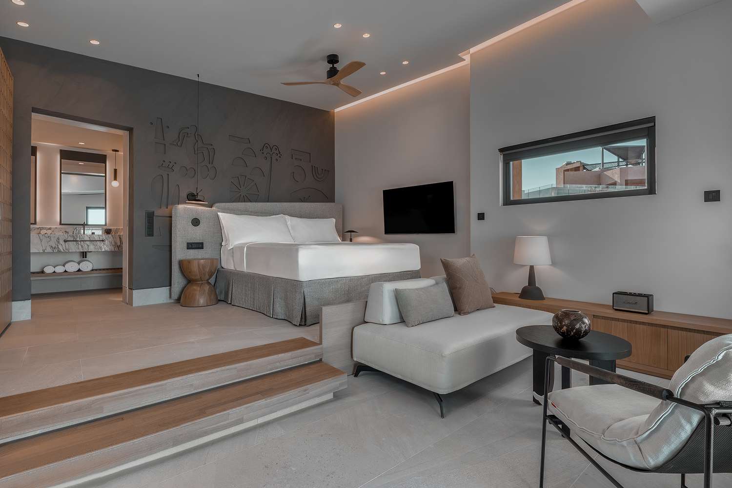 Modern bedroom with a cozy bed and minimalist design.