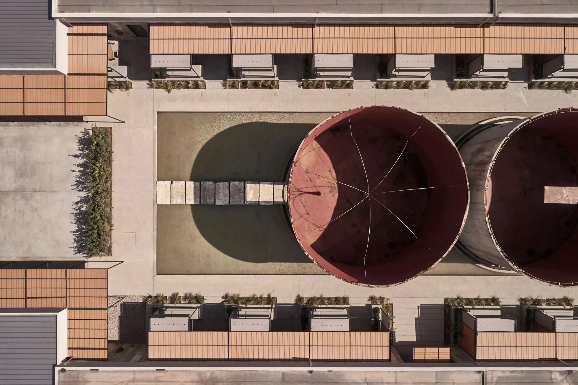 Dexamenes Seaside Hotel Kourouta - restored 1920s wine tanks reimagined as minimalist beachfront suites on the Peloponnese coast of Greece.