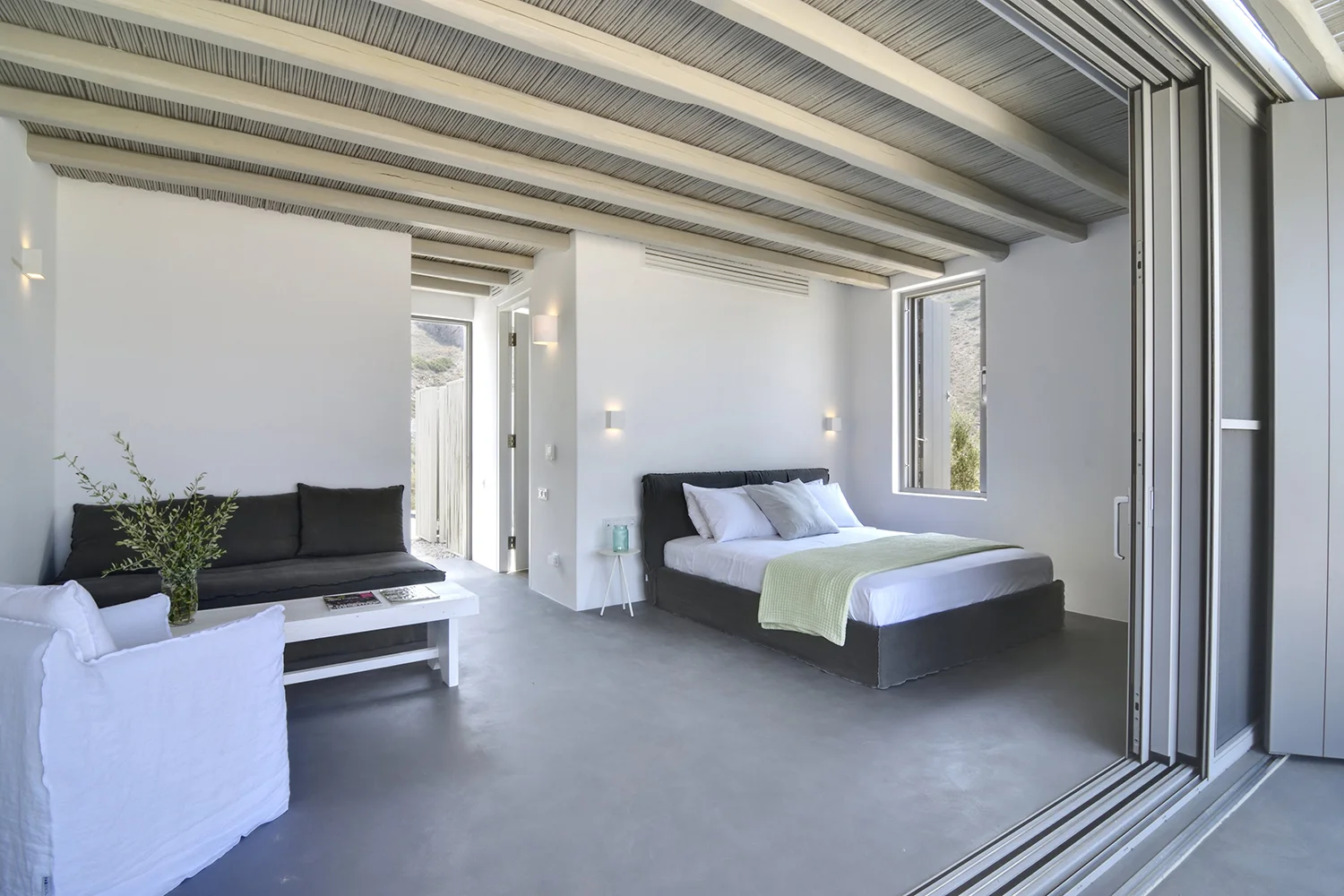 Modern bedroom with minimalist design and neutral tones.