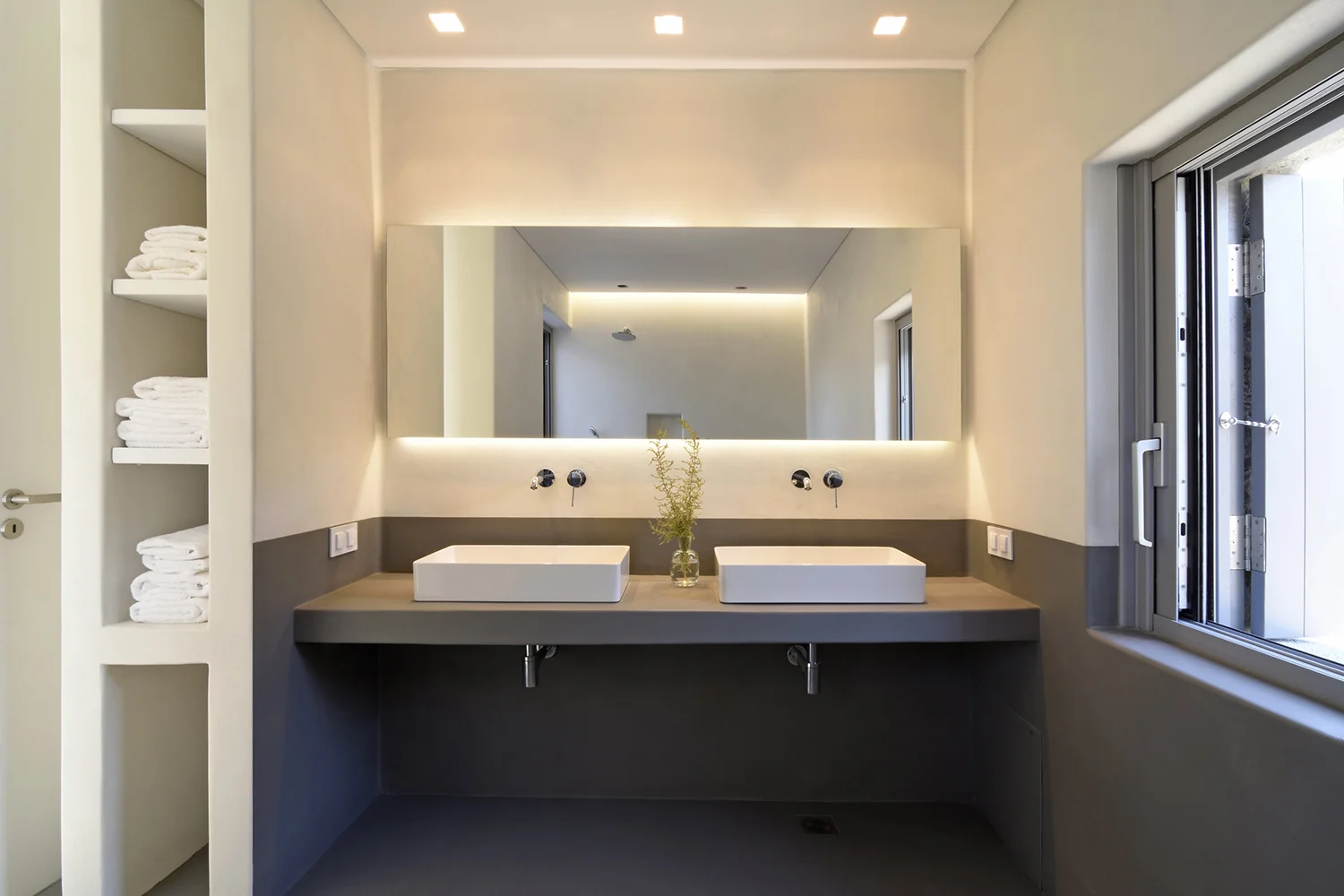 Modern bathroom with two sinks and a large mirror.