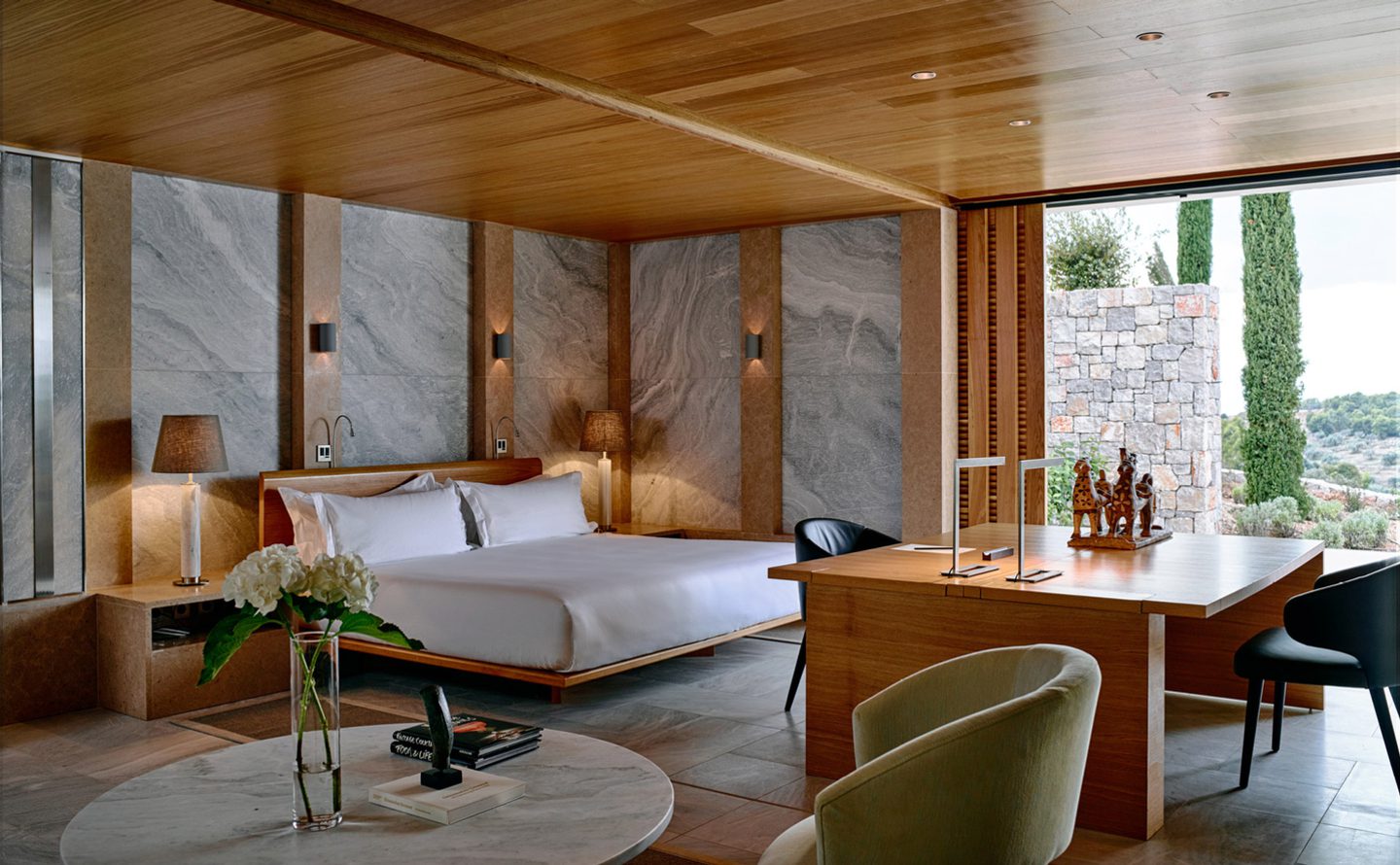 Modern hotel room with minimalist design and large windows.