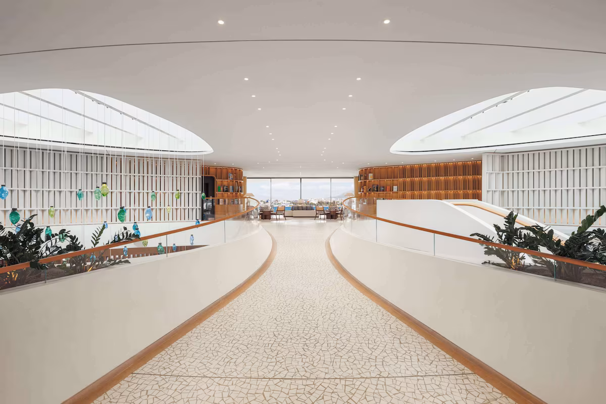 Spacious modern interior with curved pathways and large windows.