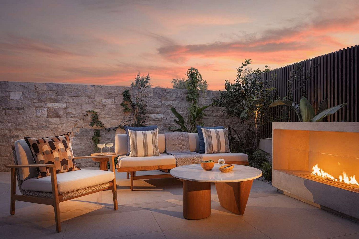 Cozy outdoor seating area with sunset view and warm lighting.