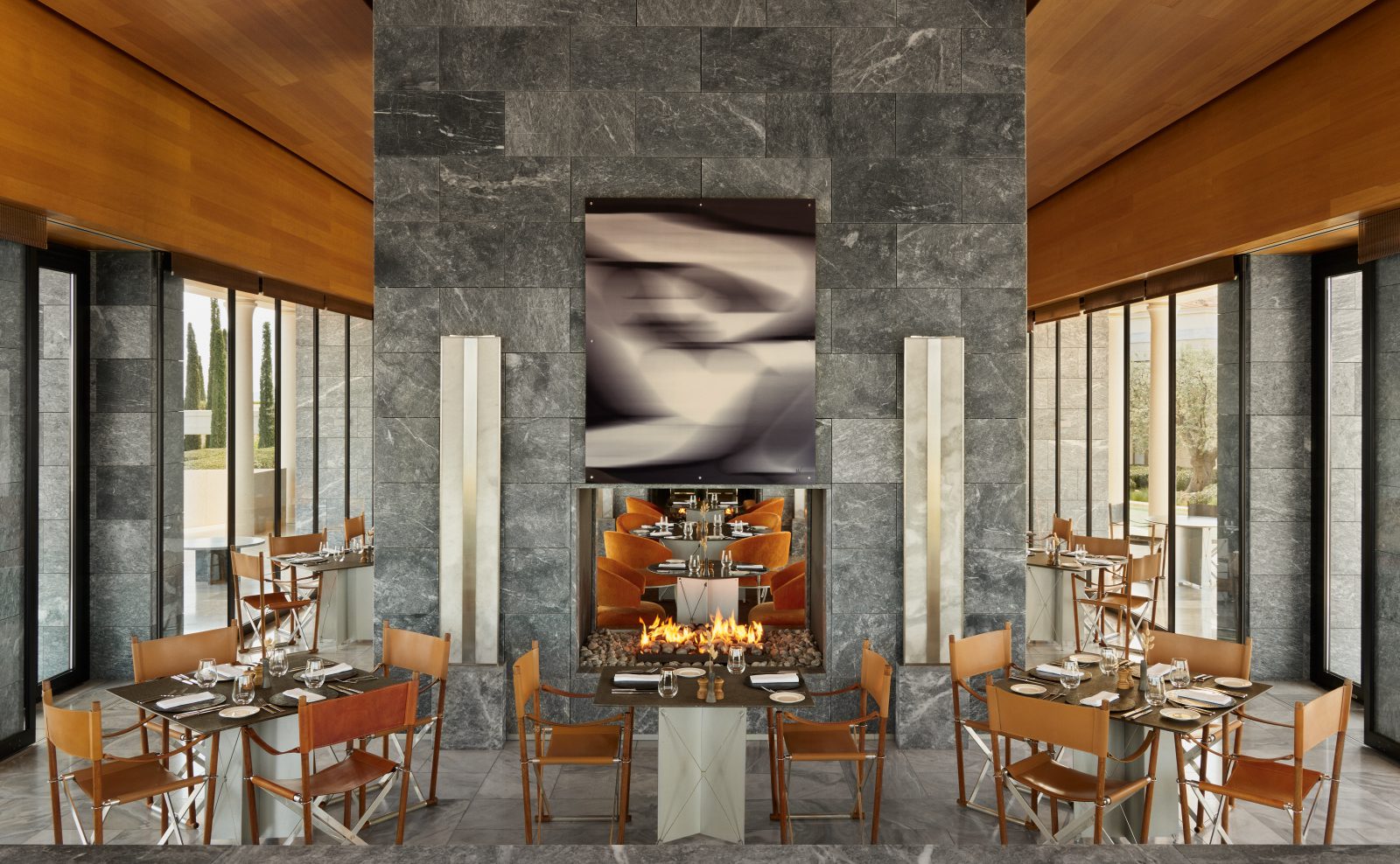 Elegant dining area with a modern fireplace and artistic wall decor.