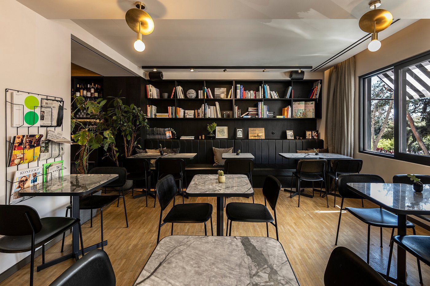 Cozy modern library with black bookshelves and seating.