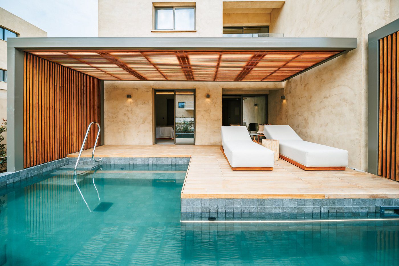 Modern poolside lounge area with comfortable seating and open design.