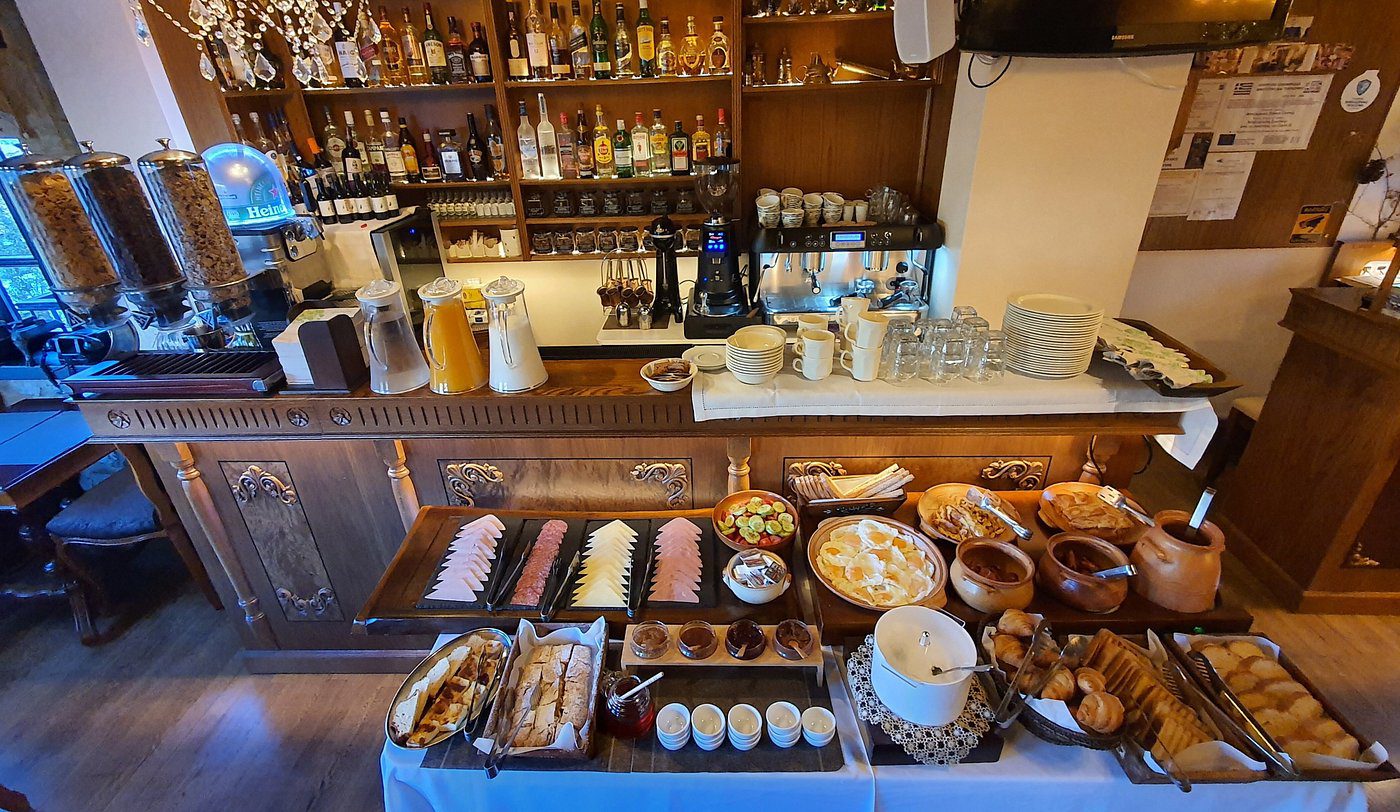 A cozy cafe counter with pastries, coffee, and tea supplies.