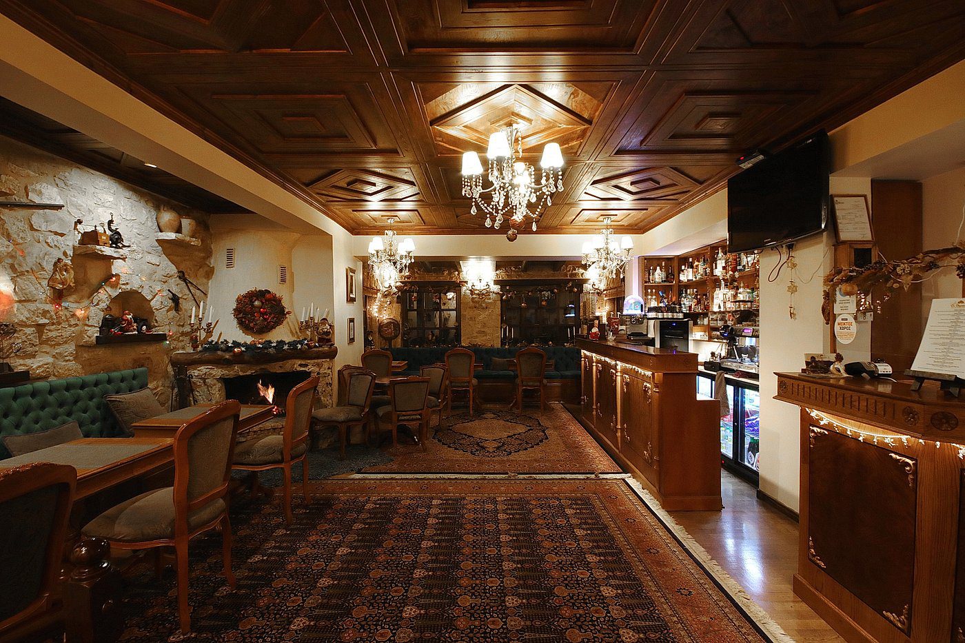 Cozy rustic kitchen with wooden beams and warm lighting.