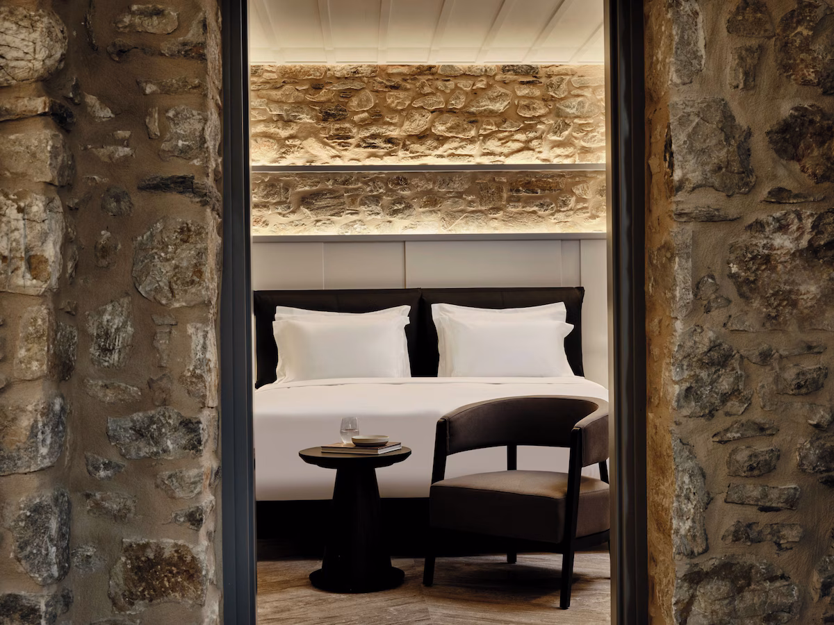 Cozy modern seating area with stone walls and soft lighting.