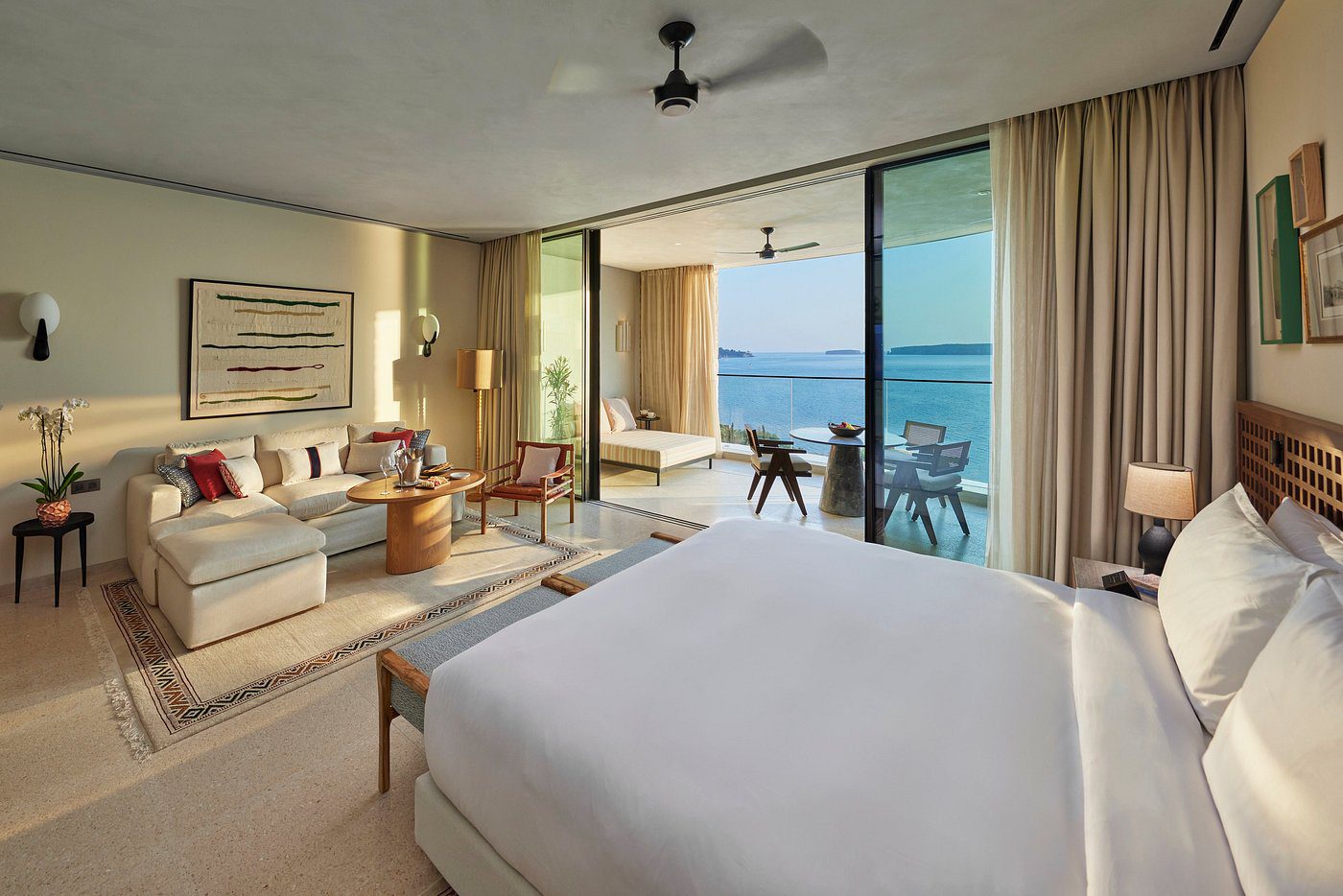 Elegant bedroom with ocean view and modern decor.