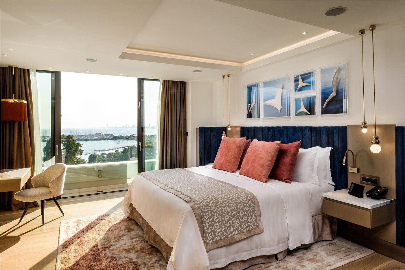 Elegant bedroom with ocean view and stylish decor.