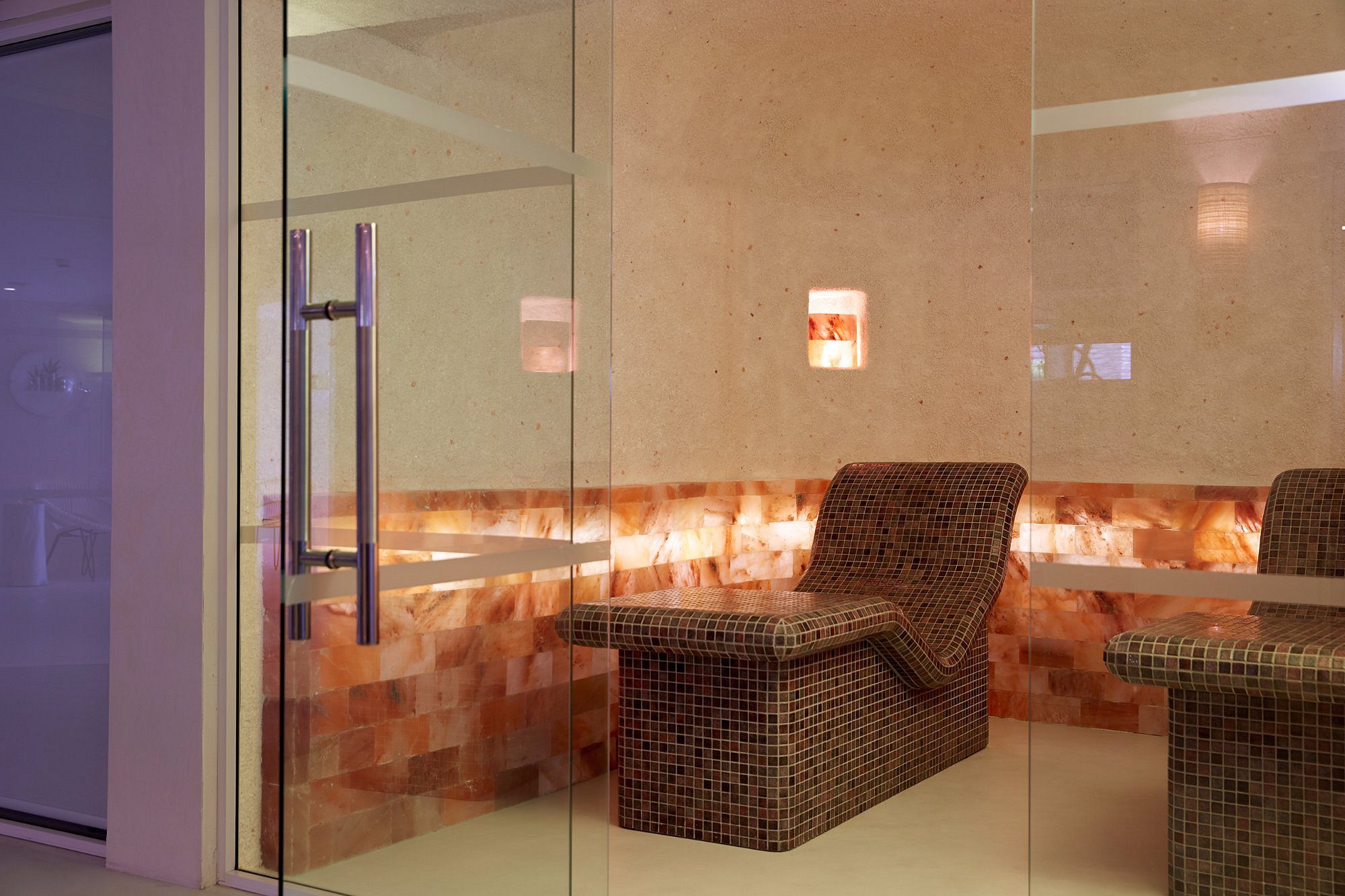 Cozy corner seating with warm lighting and wicker furniture.