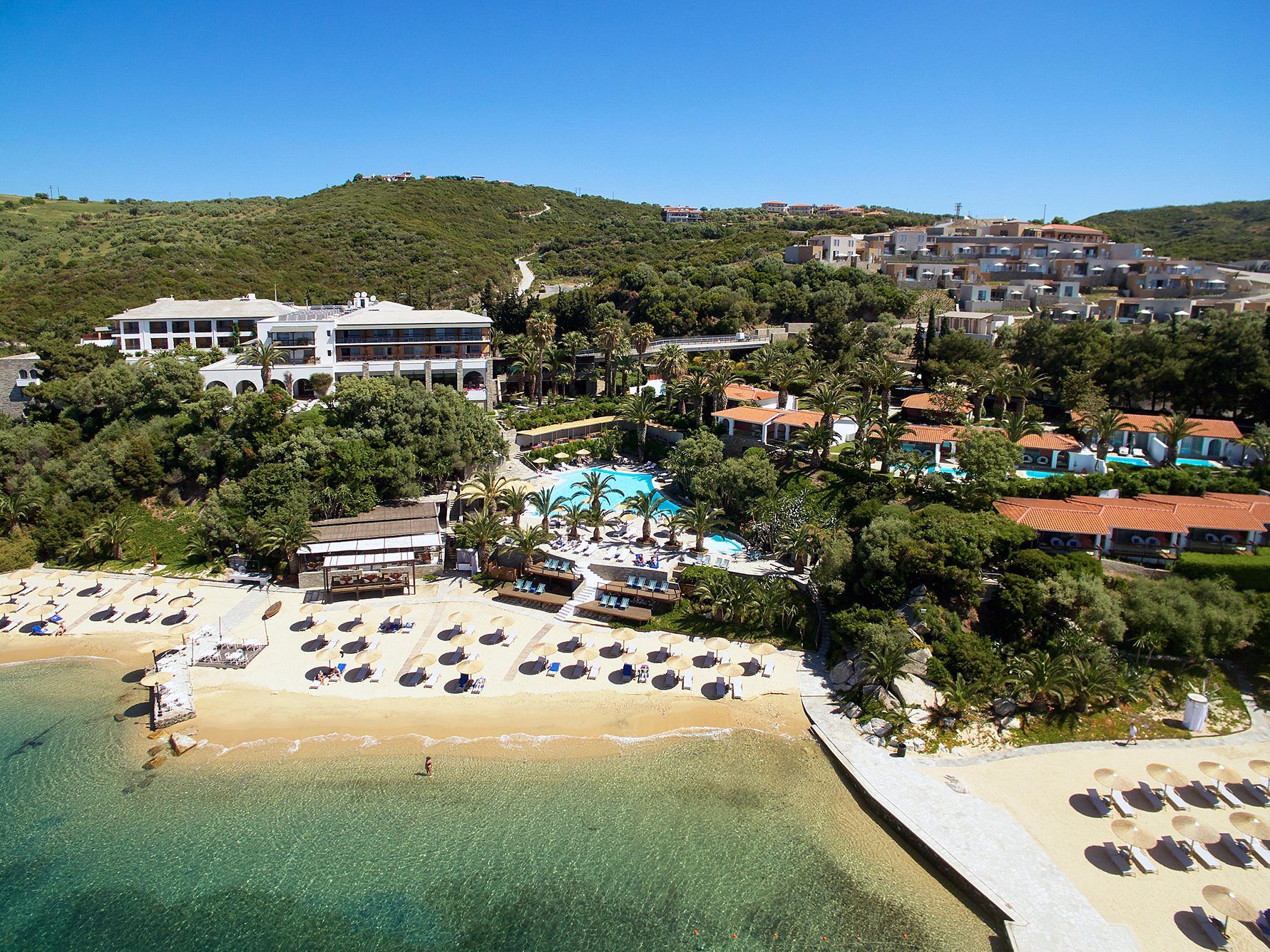 A scenic beach resort with clear waters and lush greenery.