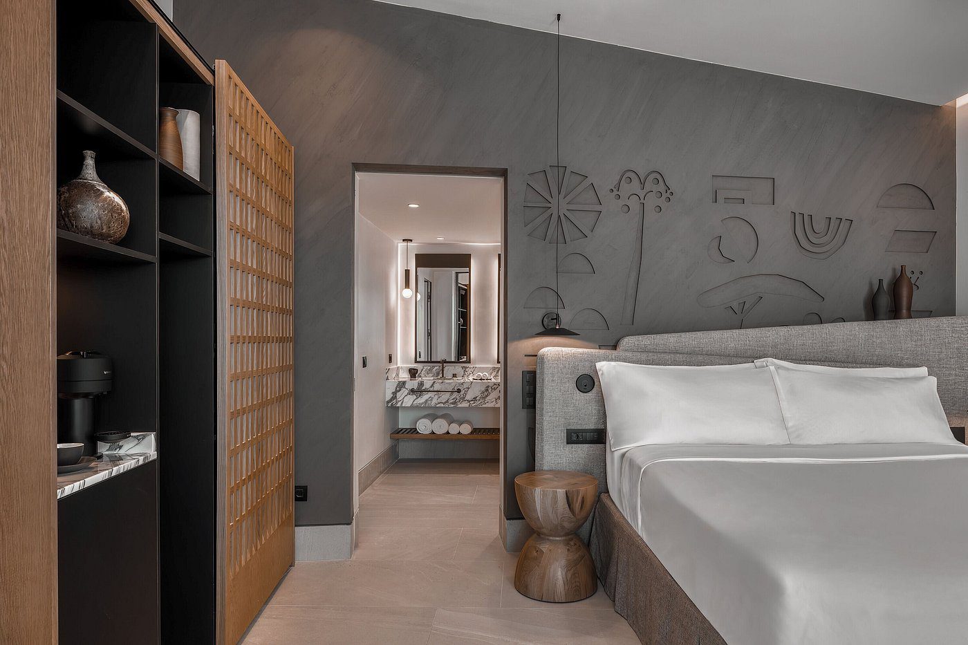 Modern bedroom with minimalist decor and neutral tones.