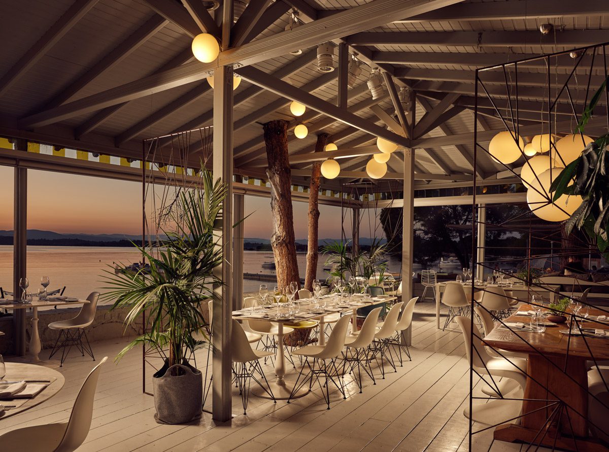 Cozy outdoor dining area with warm lighting at sunset.
