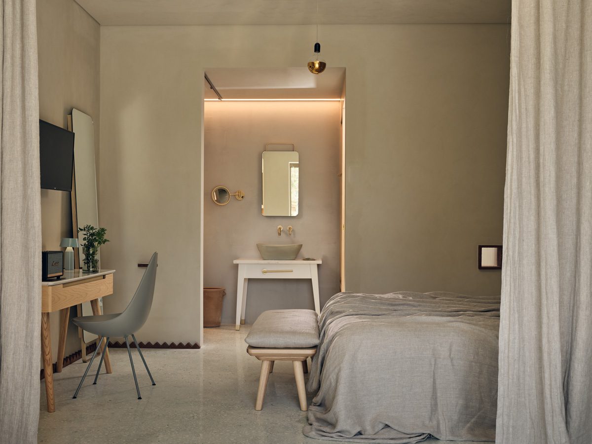 Minimalist bedroom with neutral tones and soft lighting.