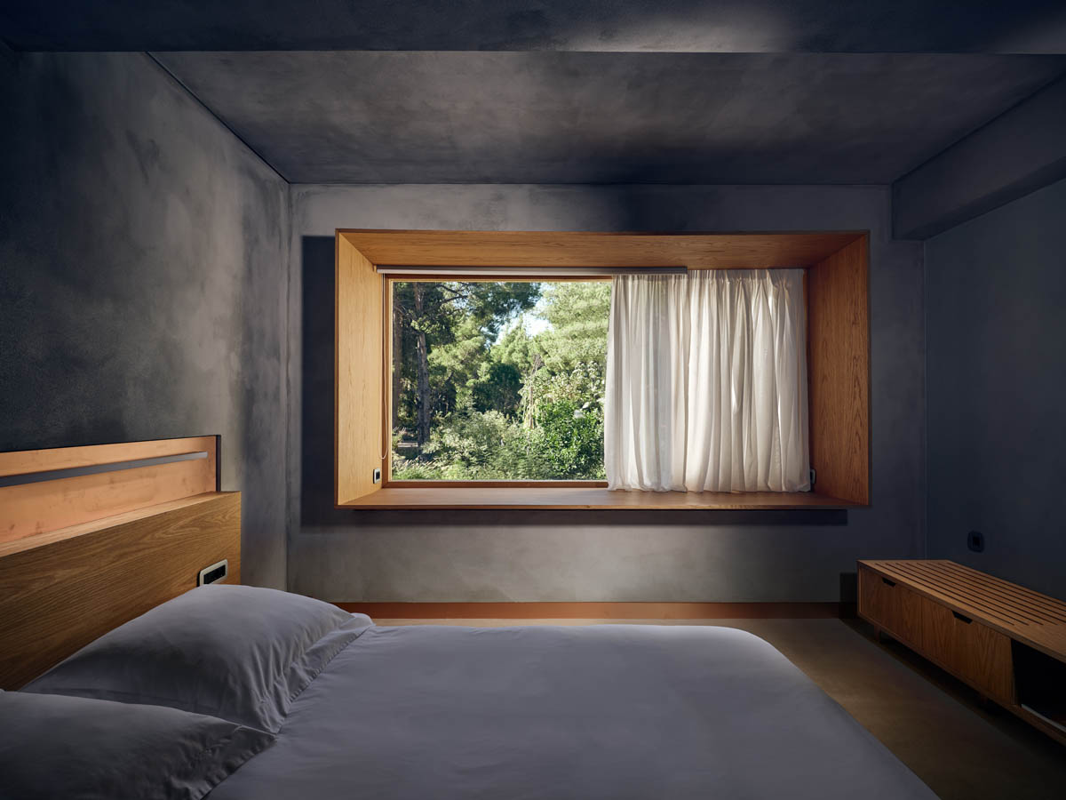 Minimalist bedroom with a large window and natural light.