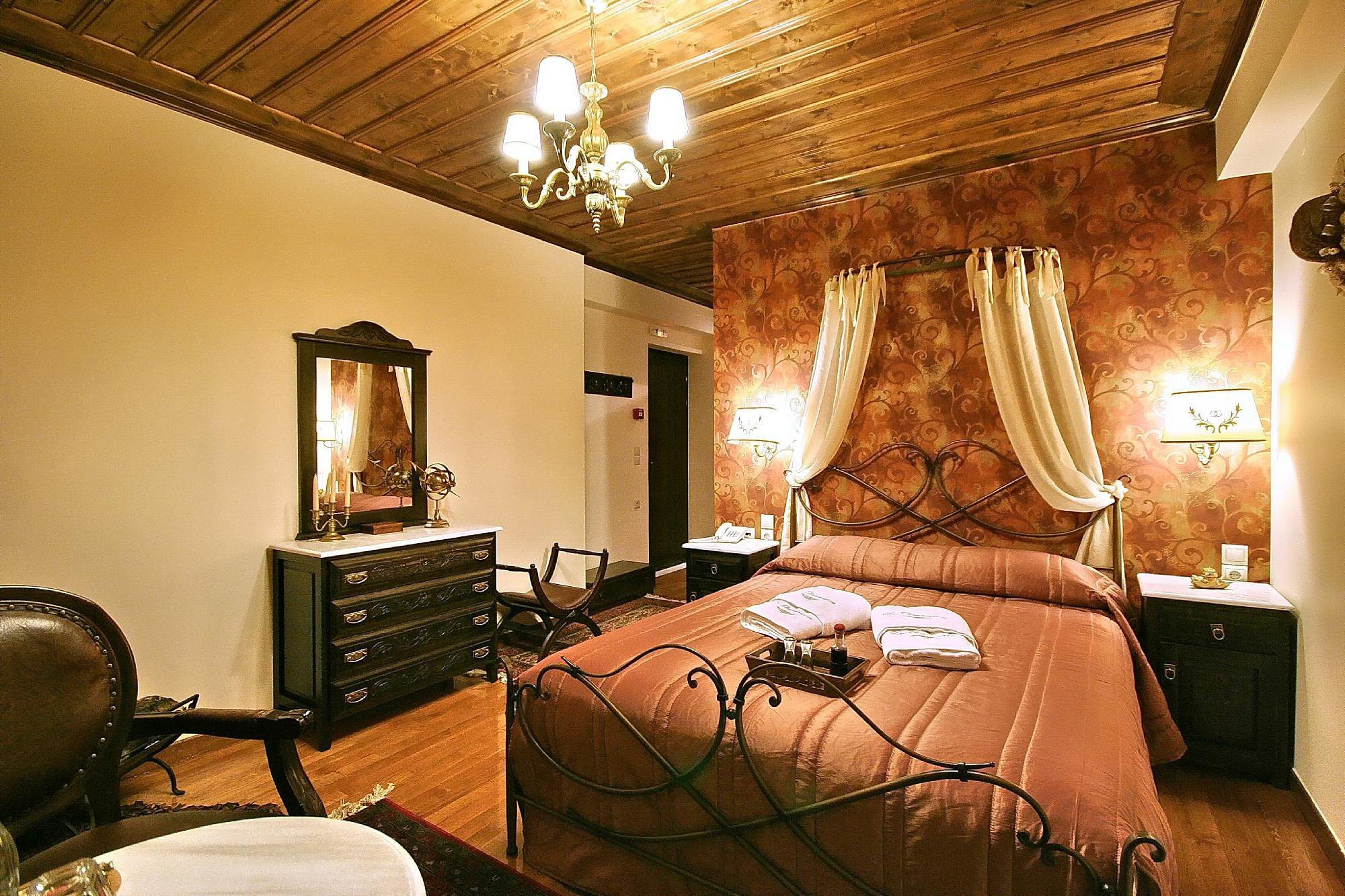 Cozy bedroom with wooden ceiling and warm lighting.