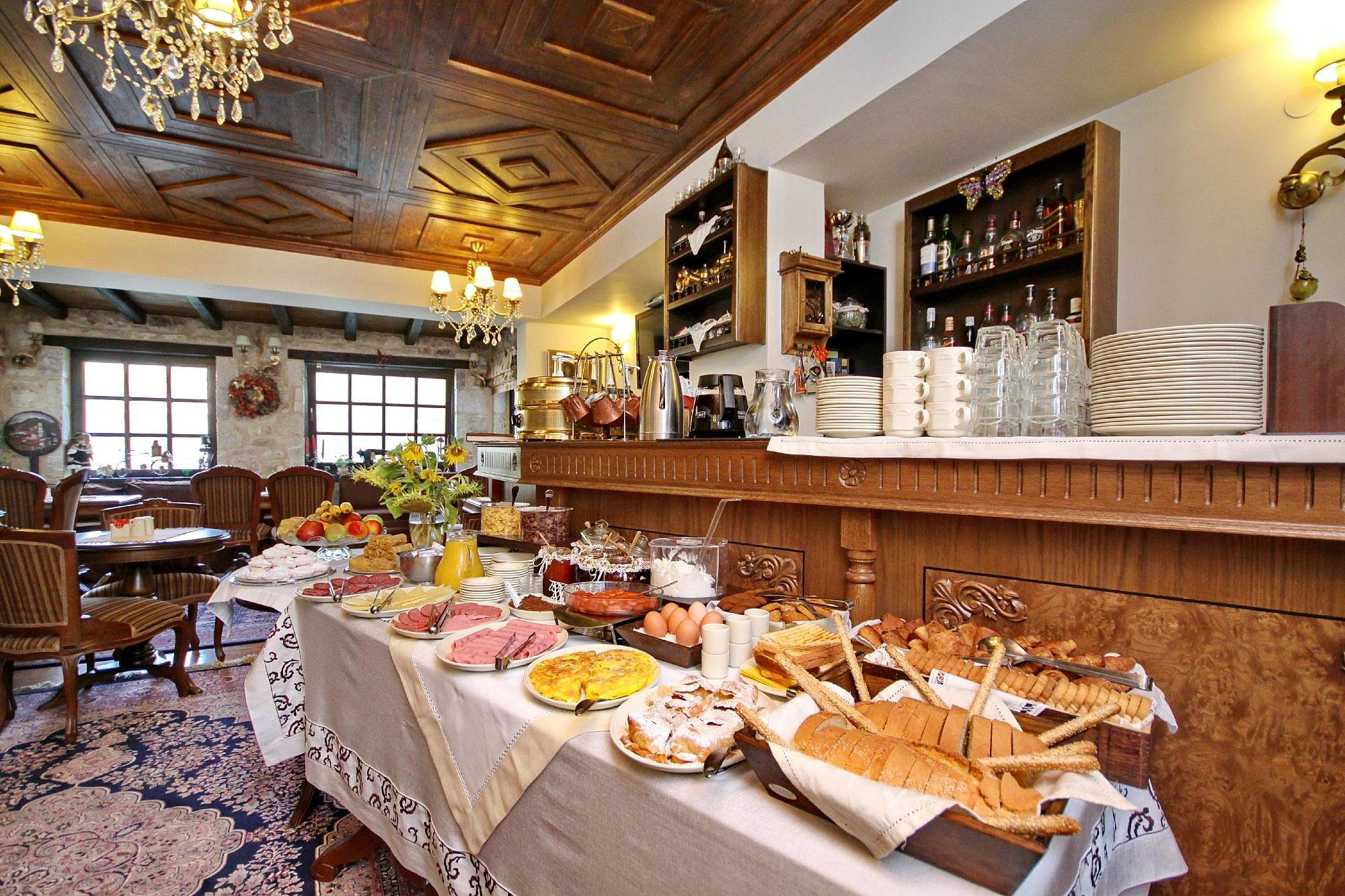 A cozy breakfast buffet with various breads and pastries.