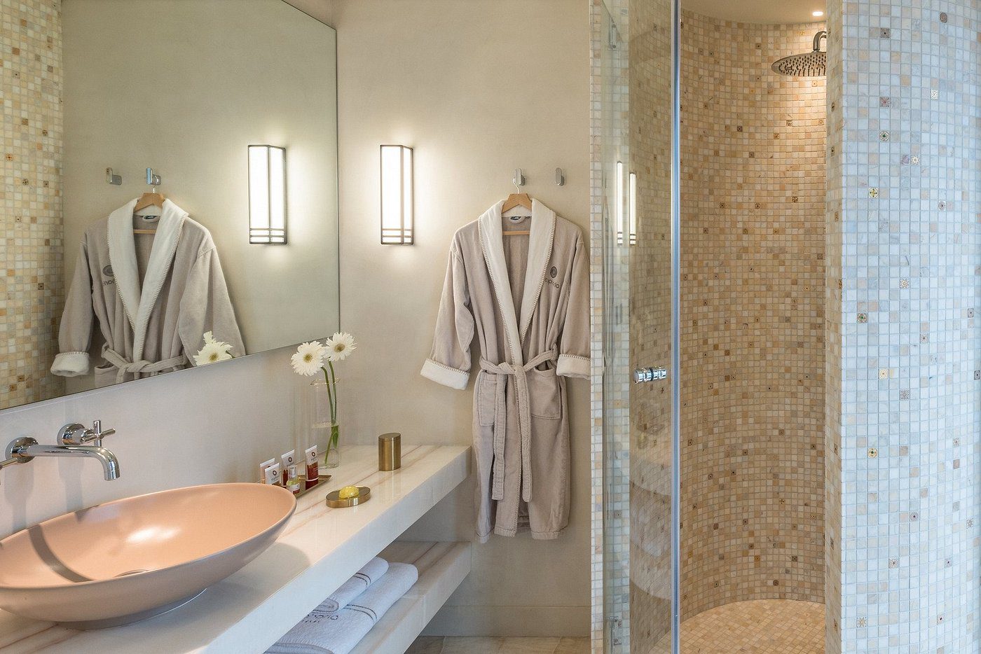 Cozy bathroom with a beige bathrobe and modern lighting.