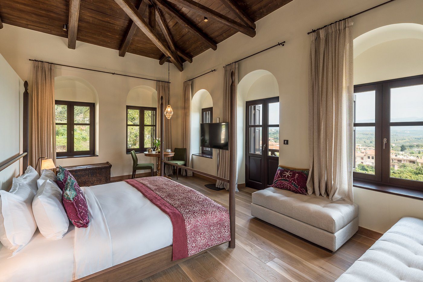 Cozy bedroom with wooden beams and elegant decor.