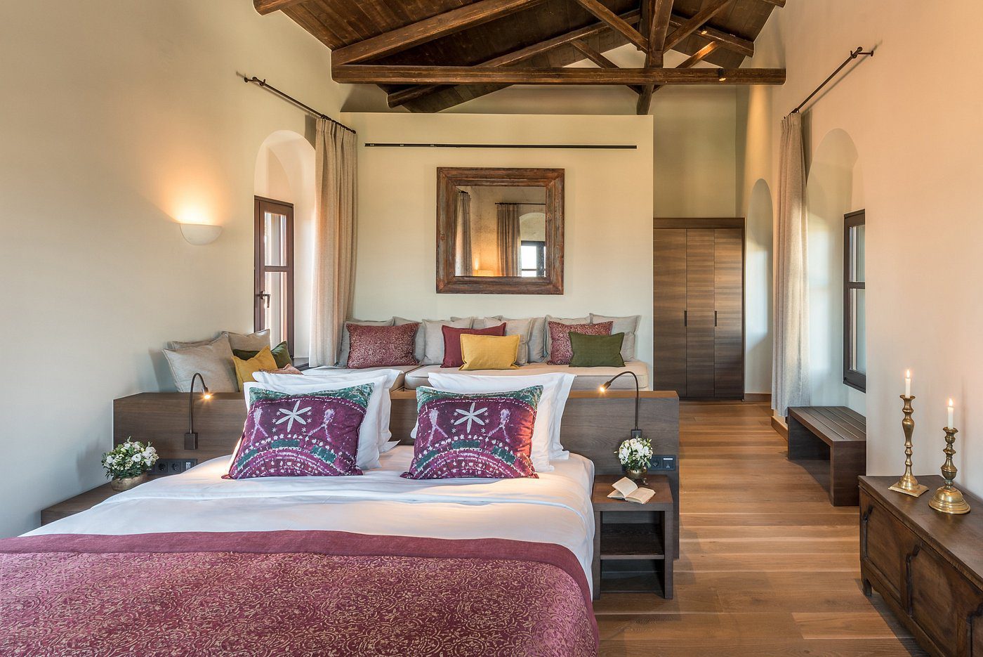 Cozy bedroom with wooden beams and elegant decor.