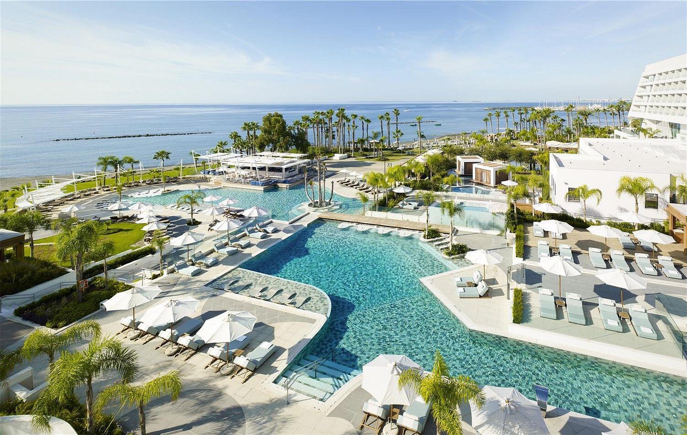 A luxurious pool area overlooking the ocean at a tropical resort.