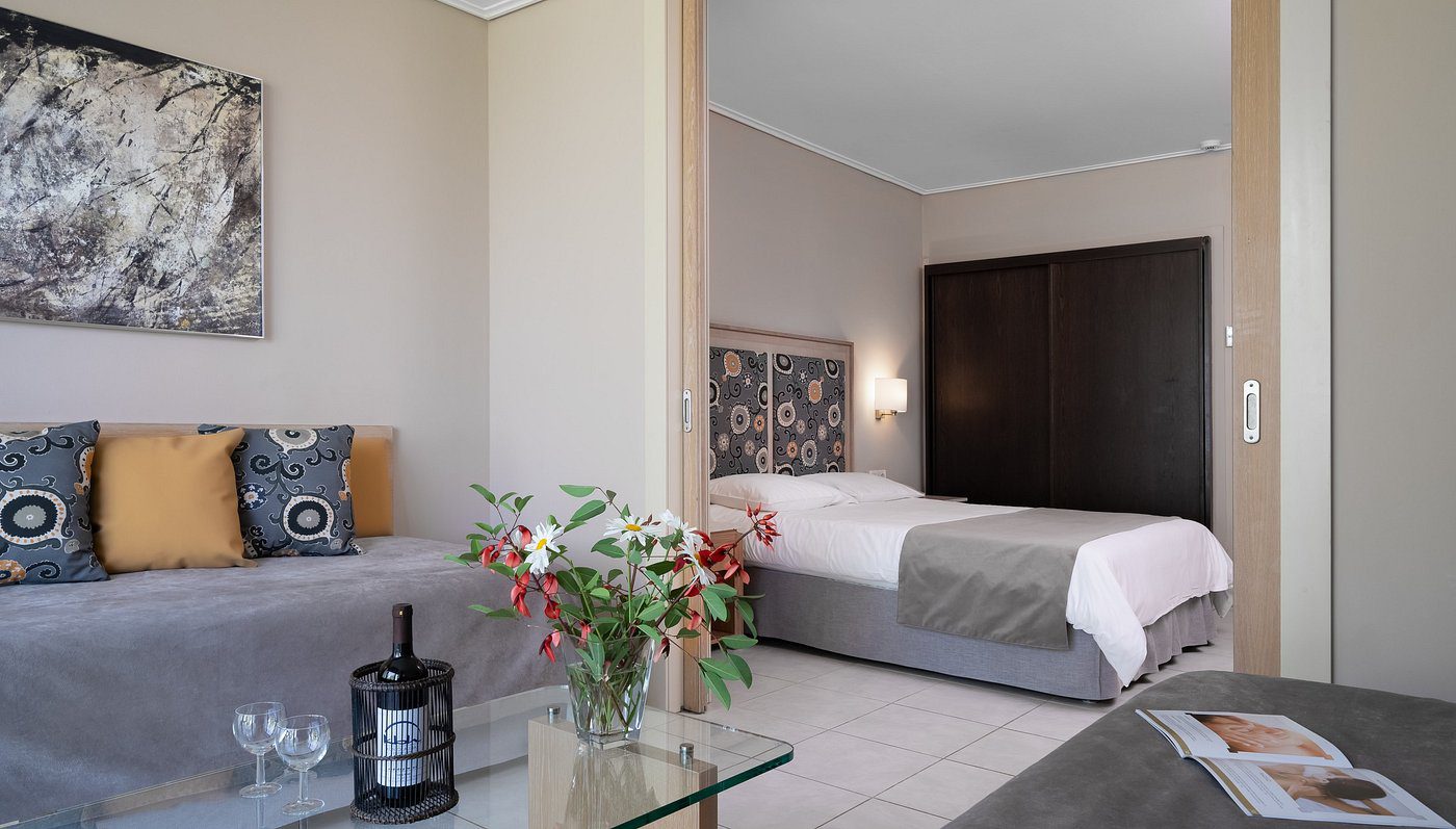 Cozy bedroom with neutral tones, floral decor, and modern furnishings.
