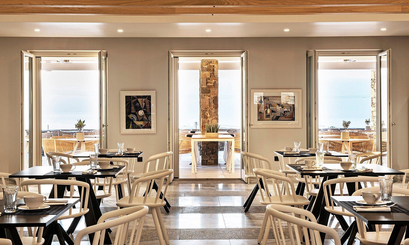 Elegant dining area with wooden chairs and modern decor.