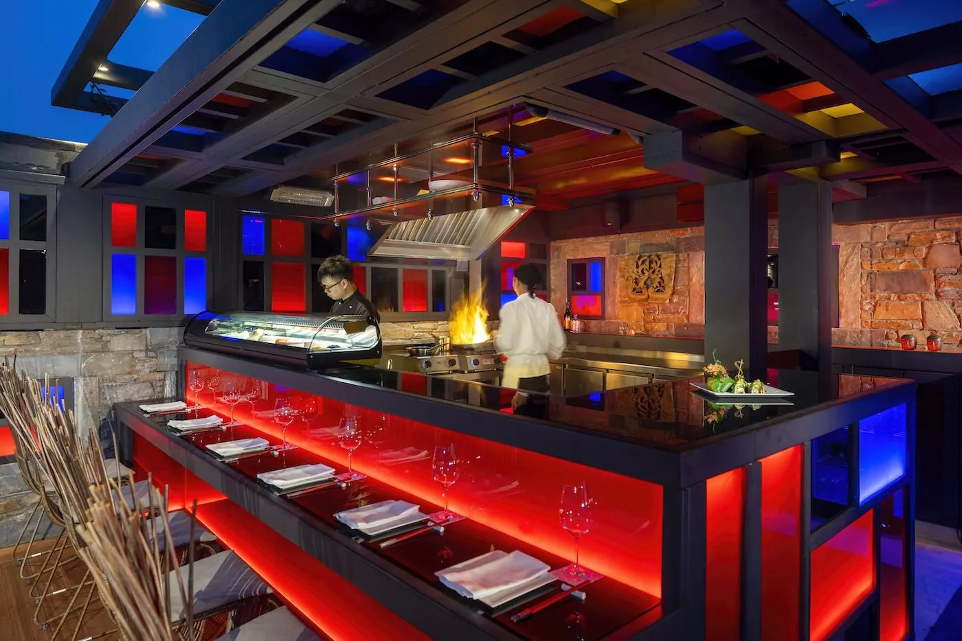 Modern bar with vibrant red lighting and a sleek interior design.