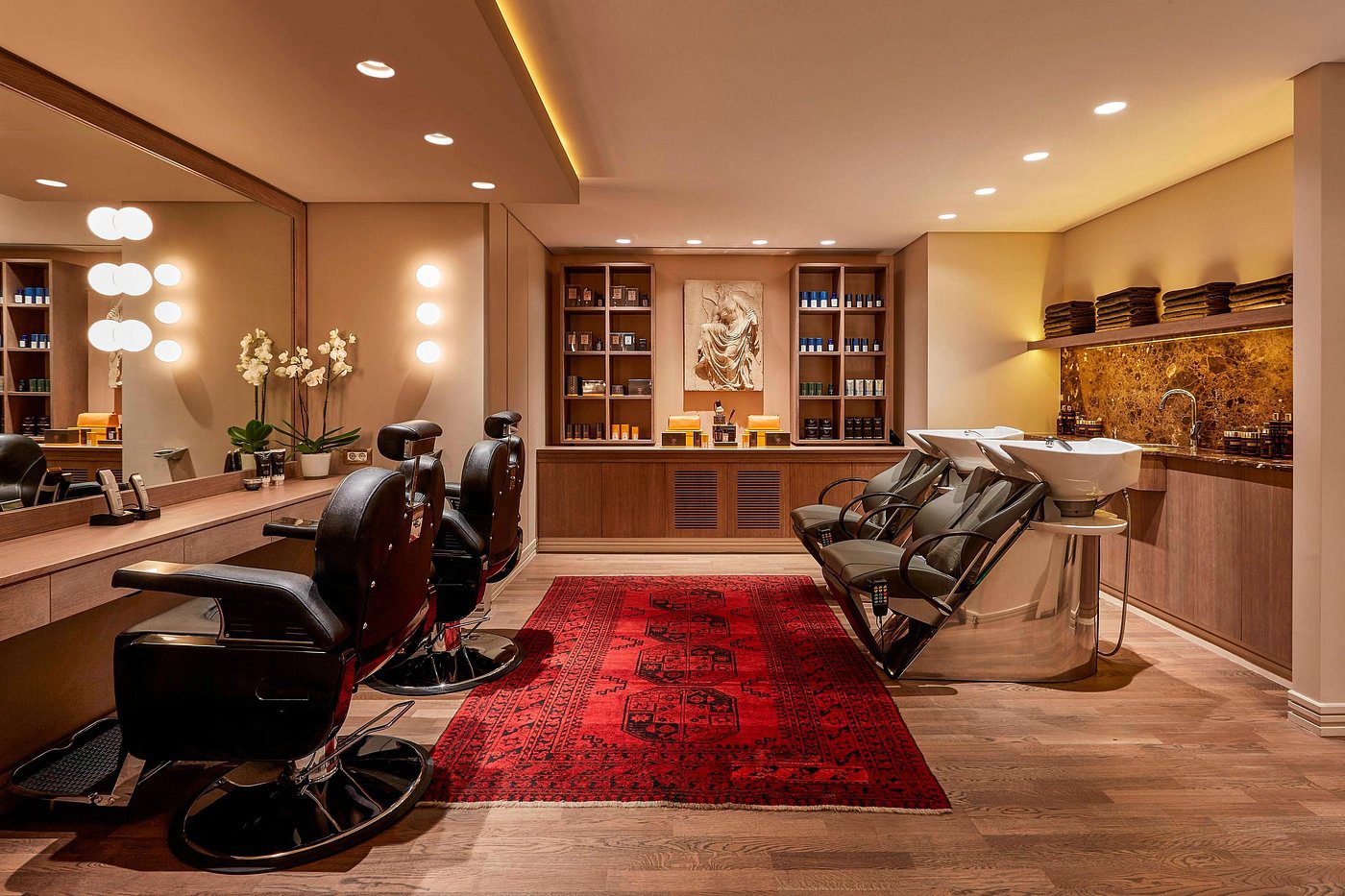 Luxurious barbershop interior with elegant chairs and warm lighting.