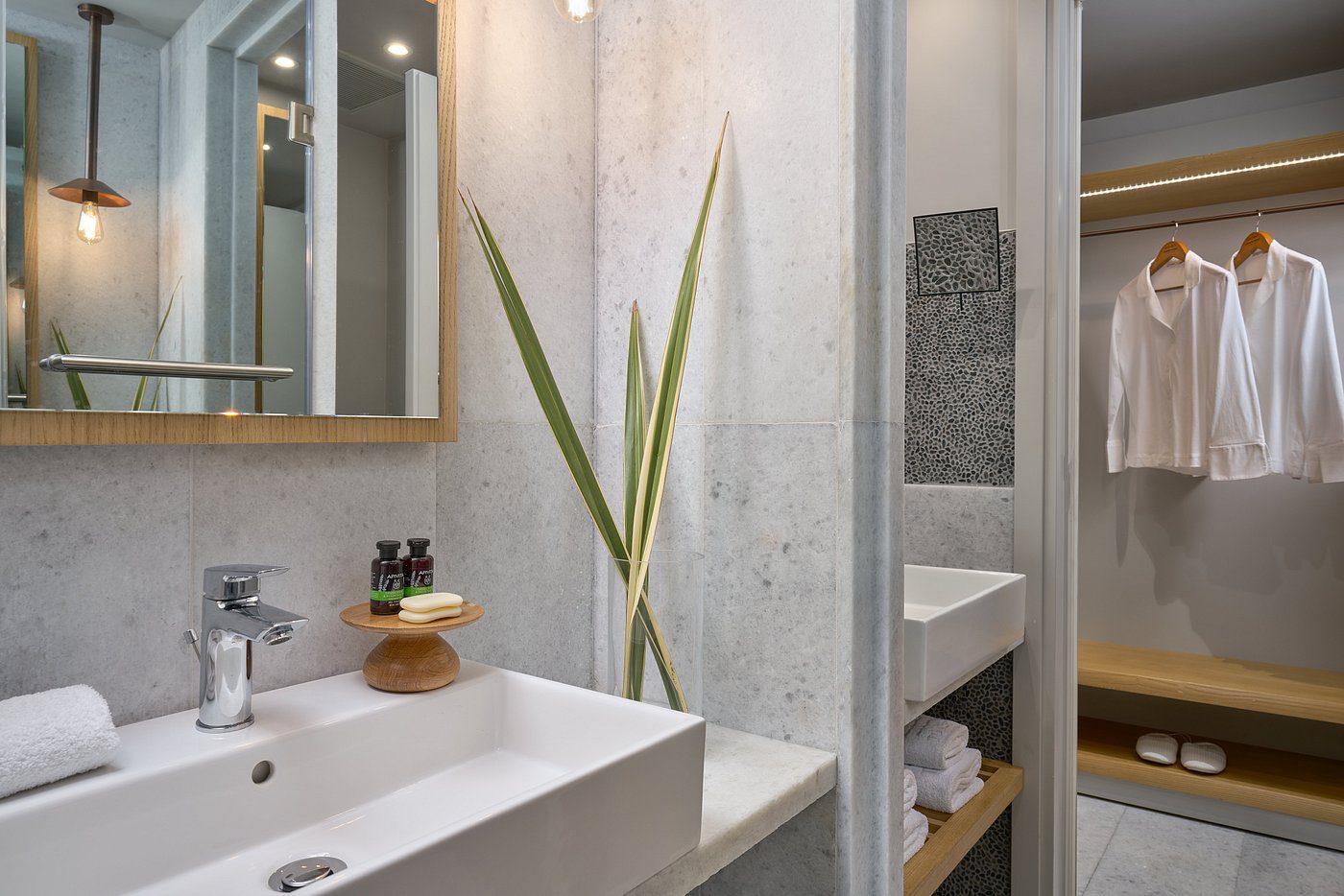 Modern bathroom with clean design and green plant accents.