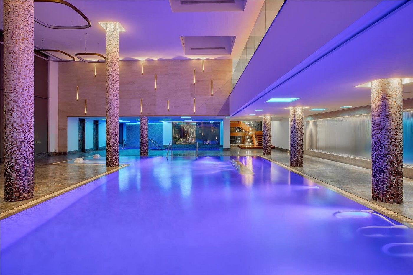 Luxurious indoor pool with ambient lighting and modern design.