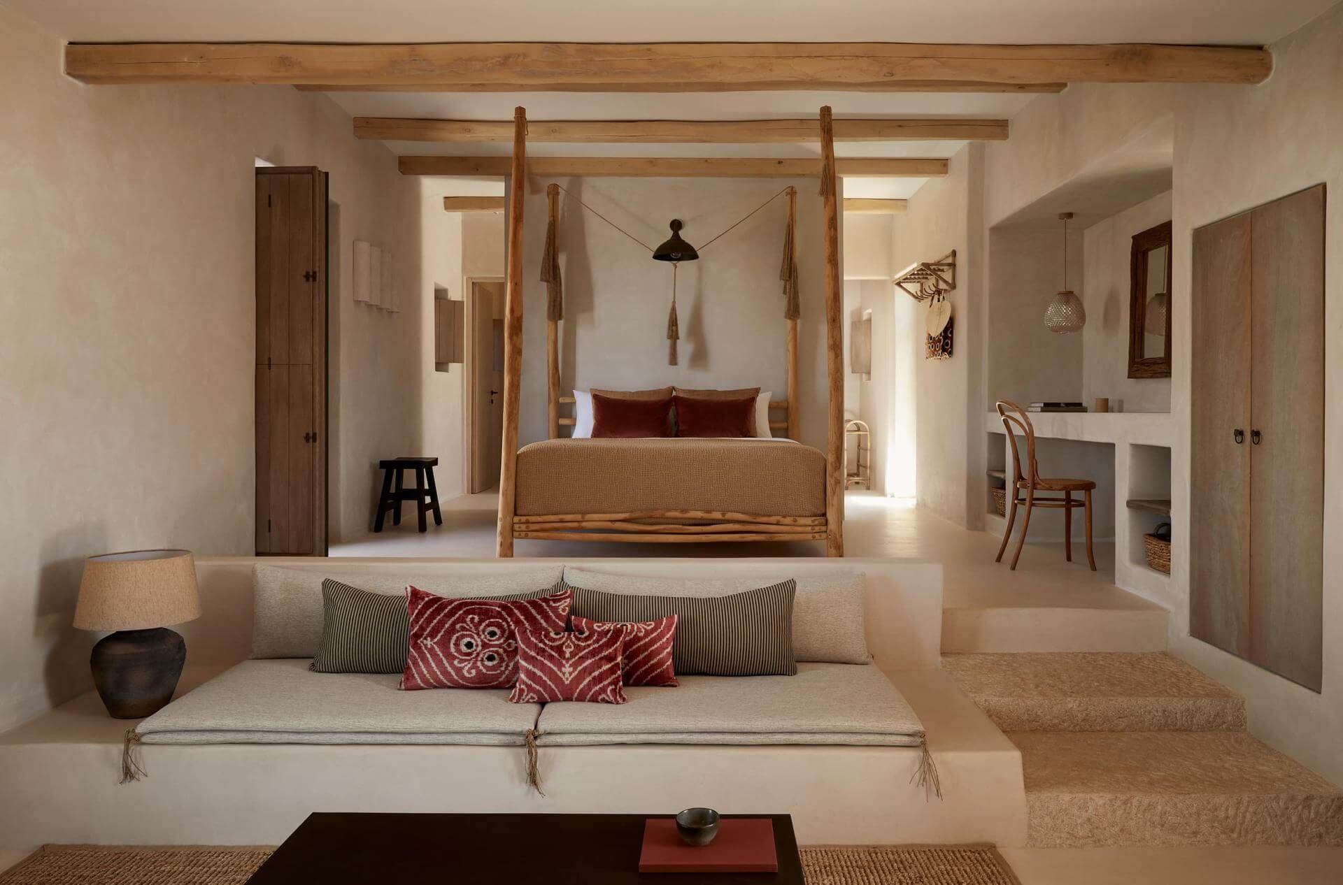 Cozy rustic bedroom with a four-poster bed and neutral-toned decor.
