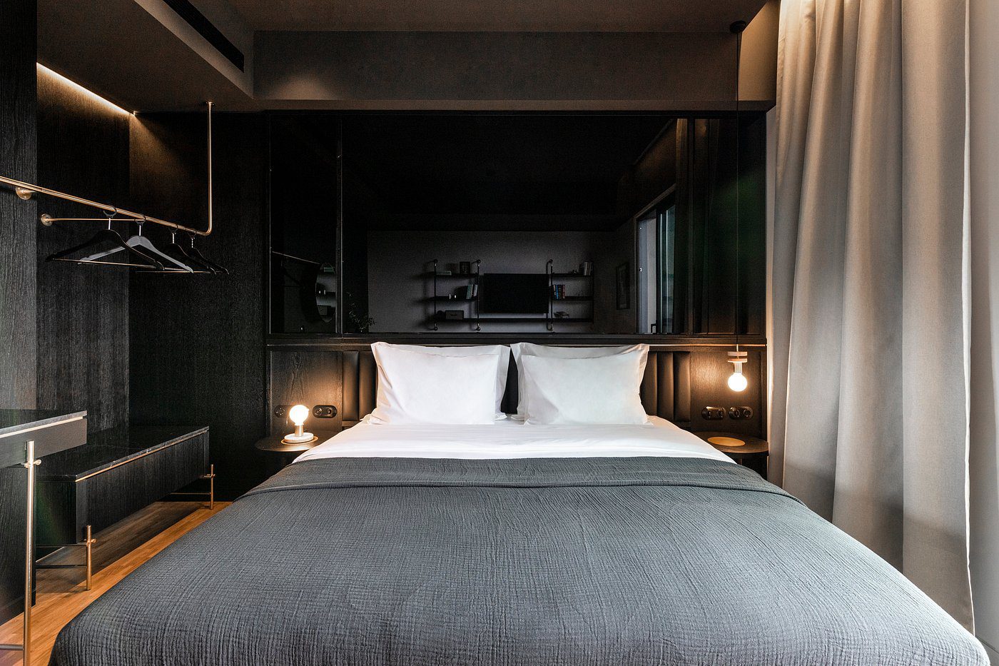 Cozy modern bedroom with a large bed and soft lighting.