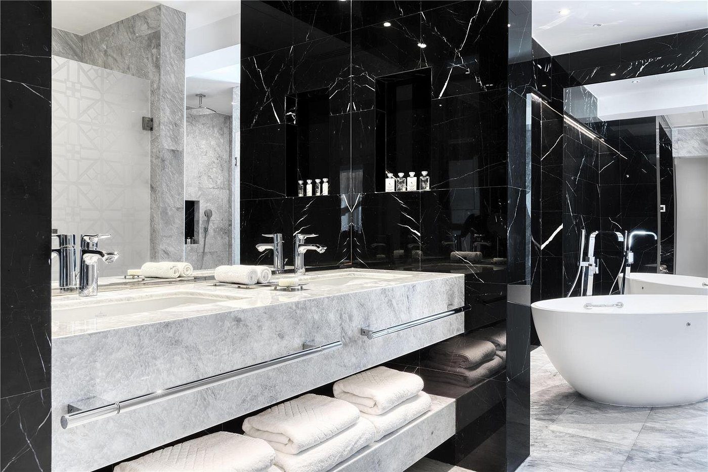 Luxurious modern bathroom with marble surfaces and elegant fixtures.