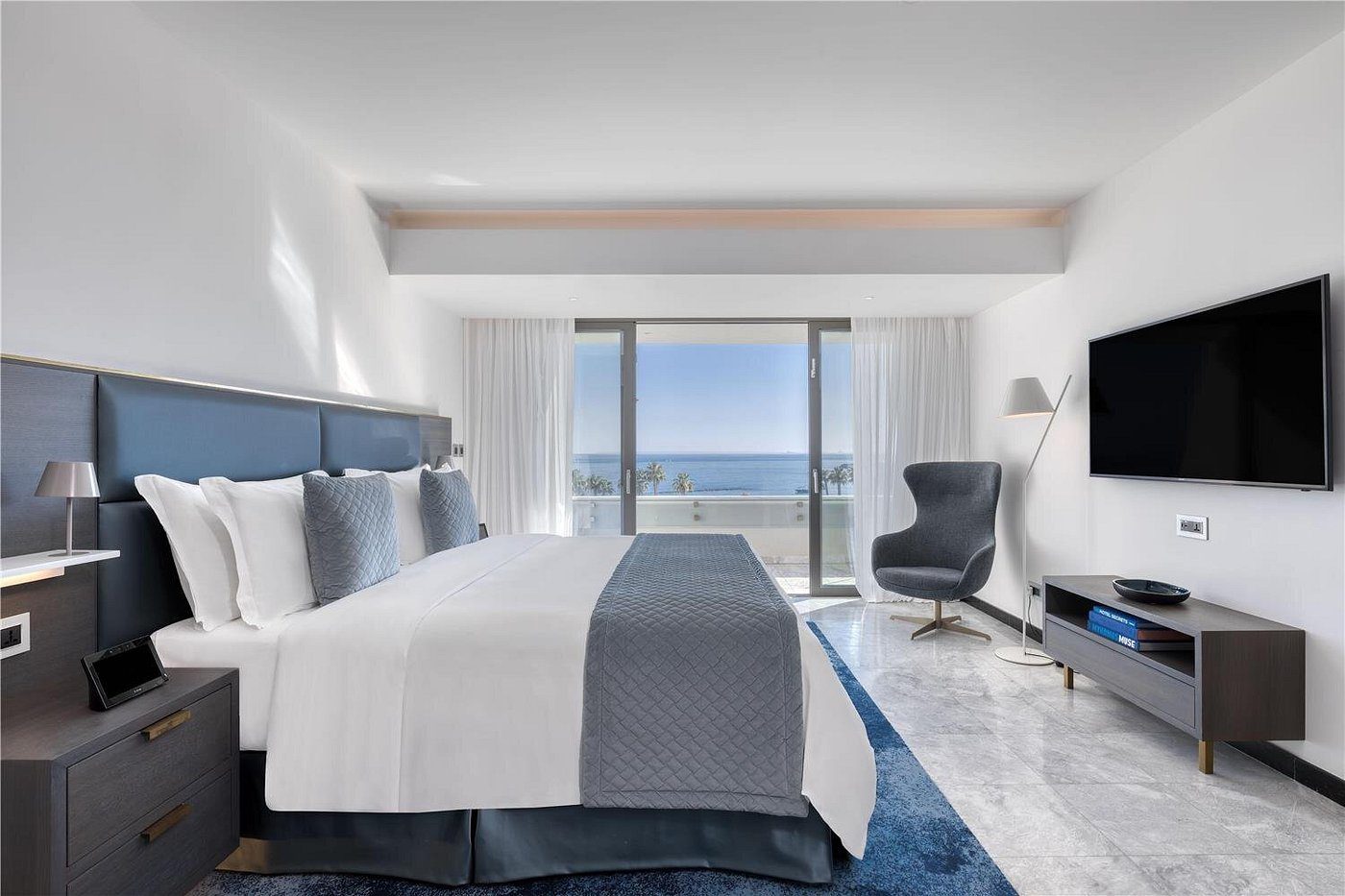 Modern hotel room with ocean view and minimalist design.