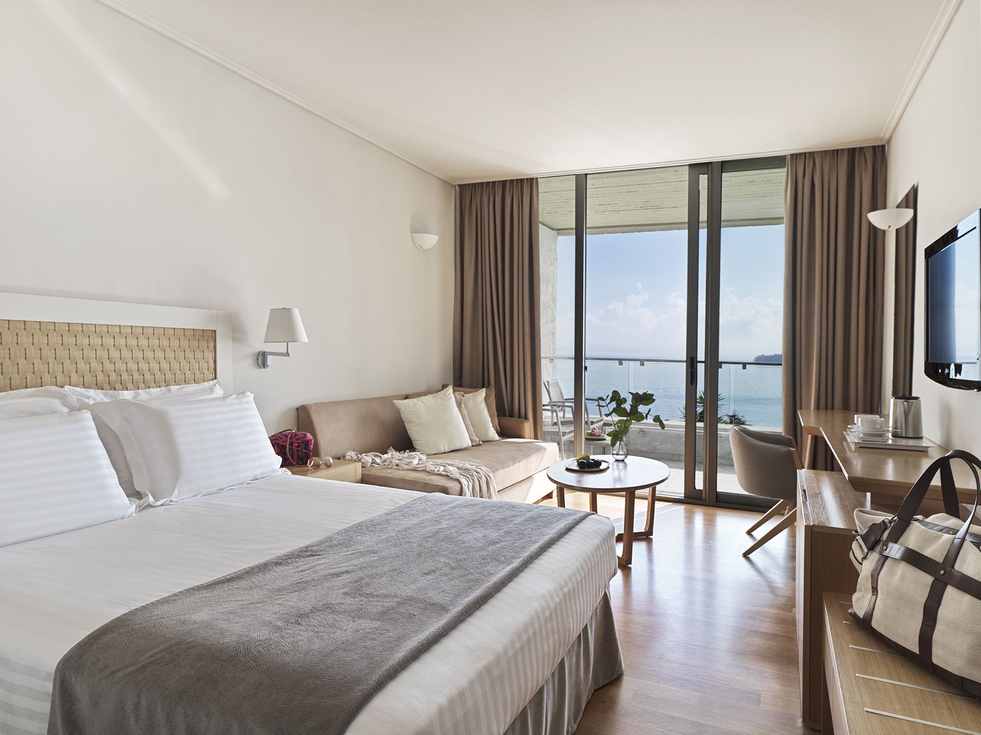 Bright hotel room with ocean view and modern decor.