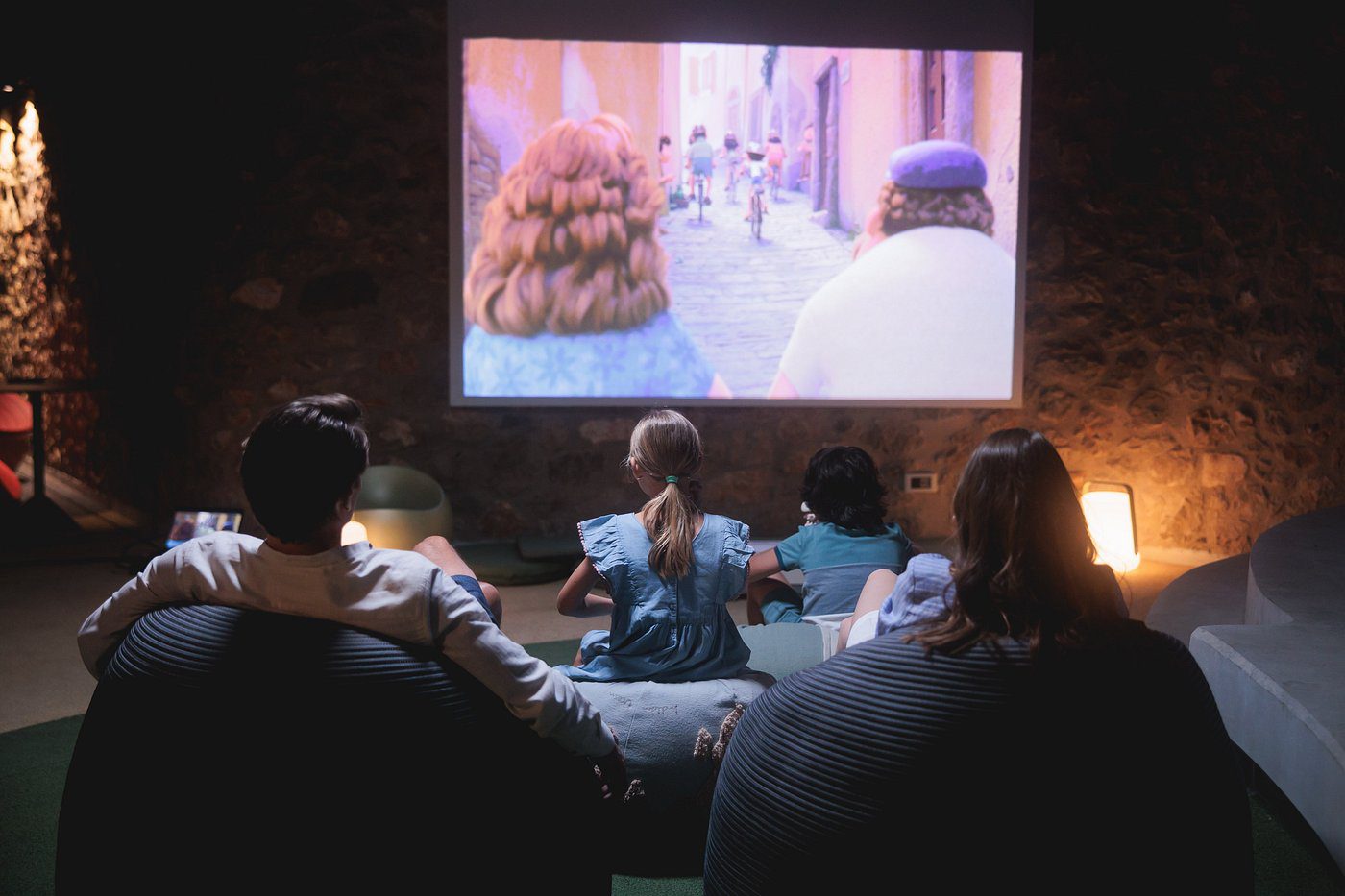 Family watching an animated movie together at home.