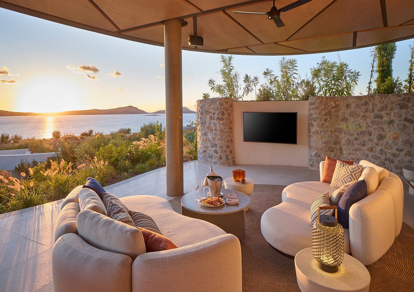 Cozy outdoor lounge with sunset views and comfortable seating.