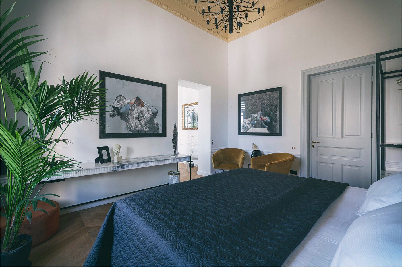 Elegant bedroom with modern decor and cozy seating area.