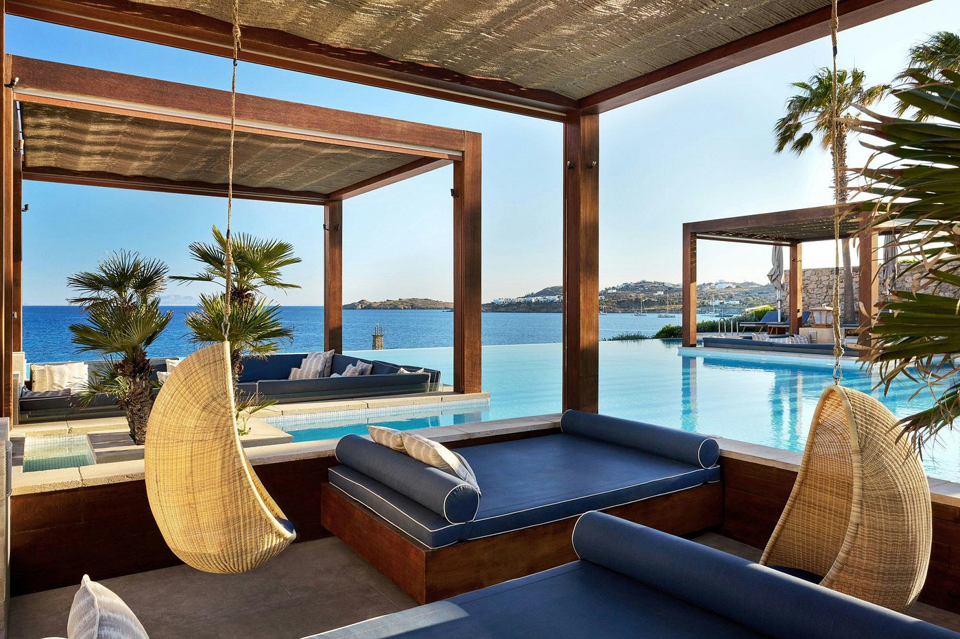 Luxurious poolside lounge with ocean views and comfortable seating.