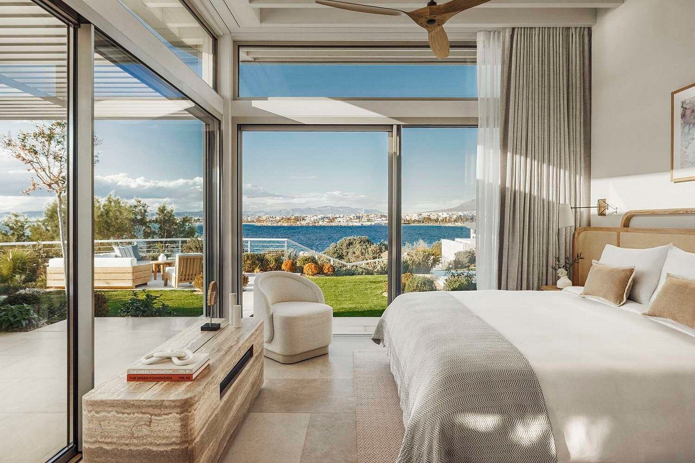Luxurious bedroom with ocean view and modern decor.