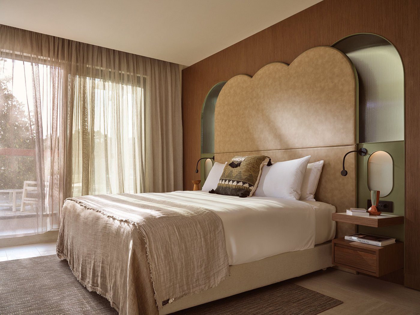 Cozy bedroom with elegant beige and brown tones and soft lighting.