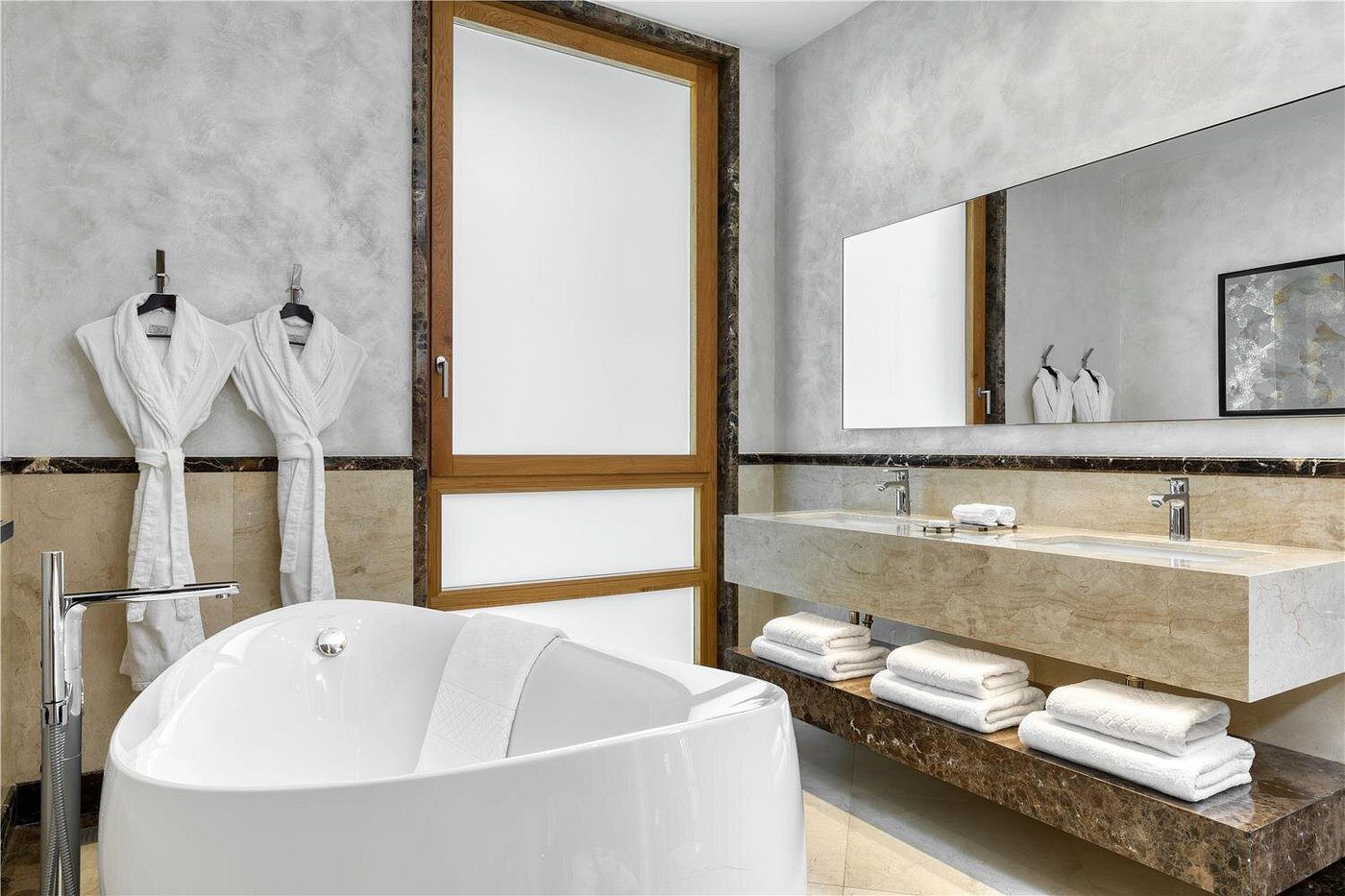Modern bathroom with a freestanding bathtub and large frosted window.