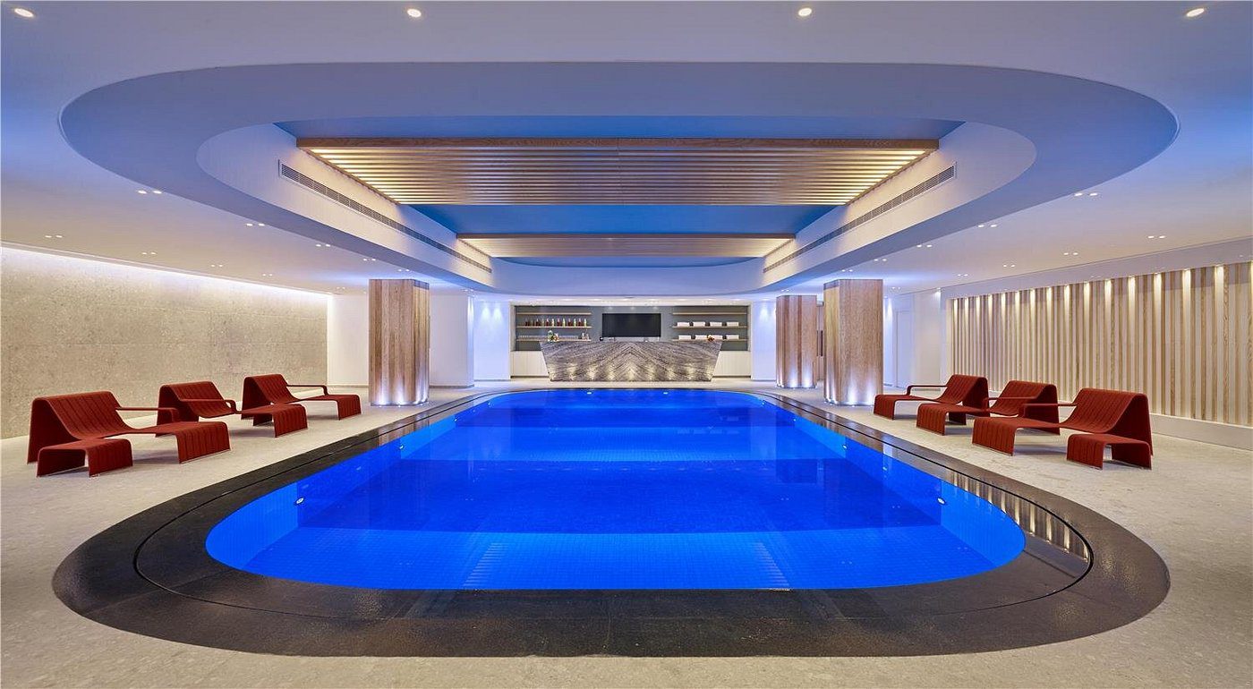 Luxurious indoor pool with modern design and comfortable seating.