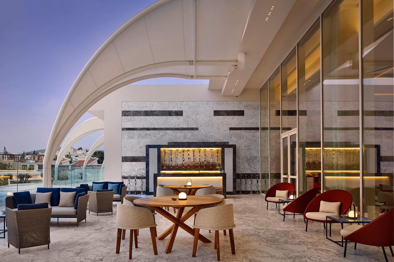 Elegant modern lounge area with curved architecture and cozy seating.