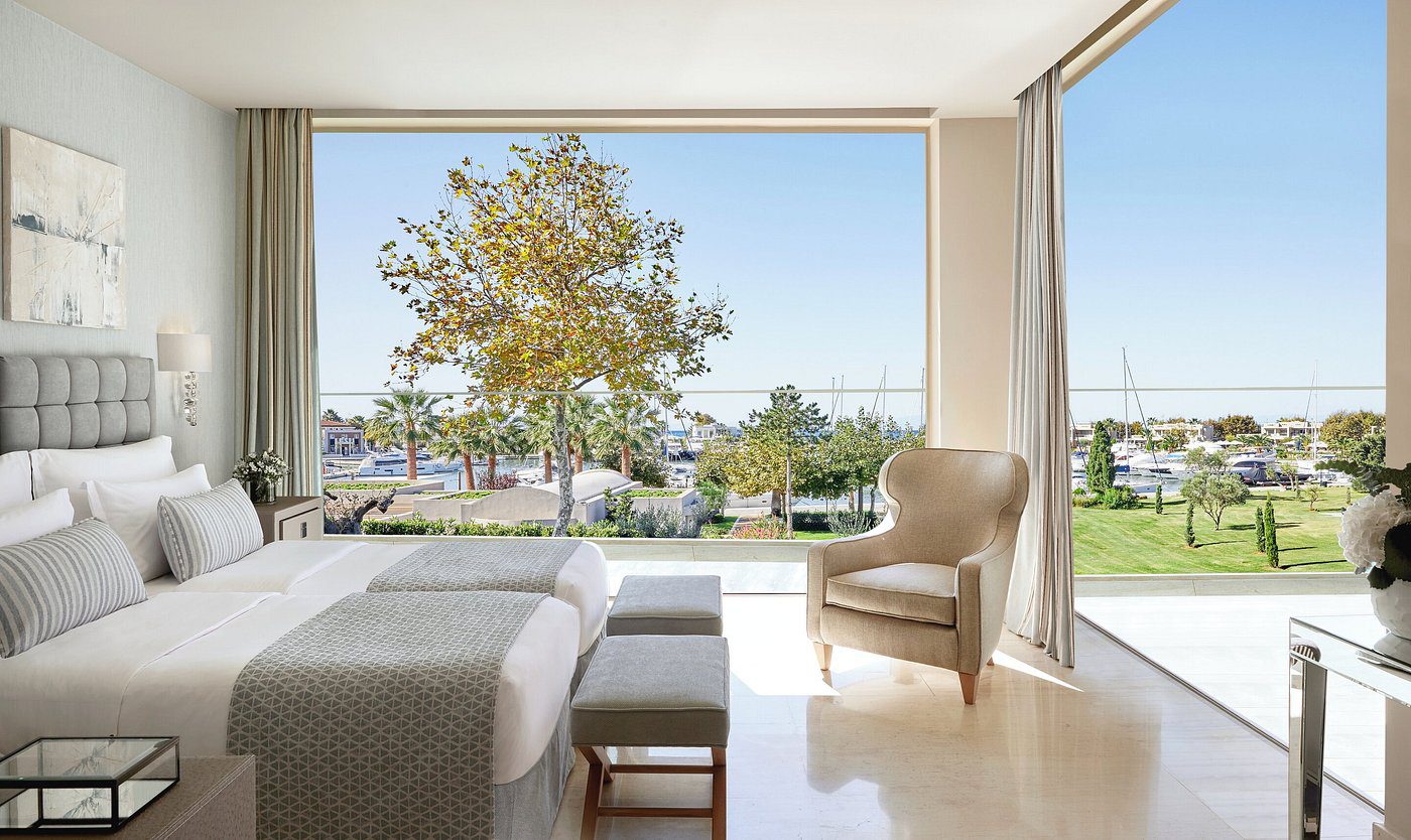Bright living room with large window overlooking a green outdoor space.