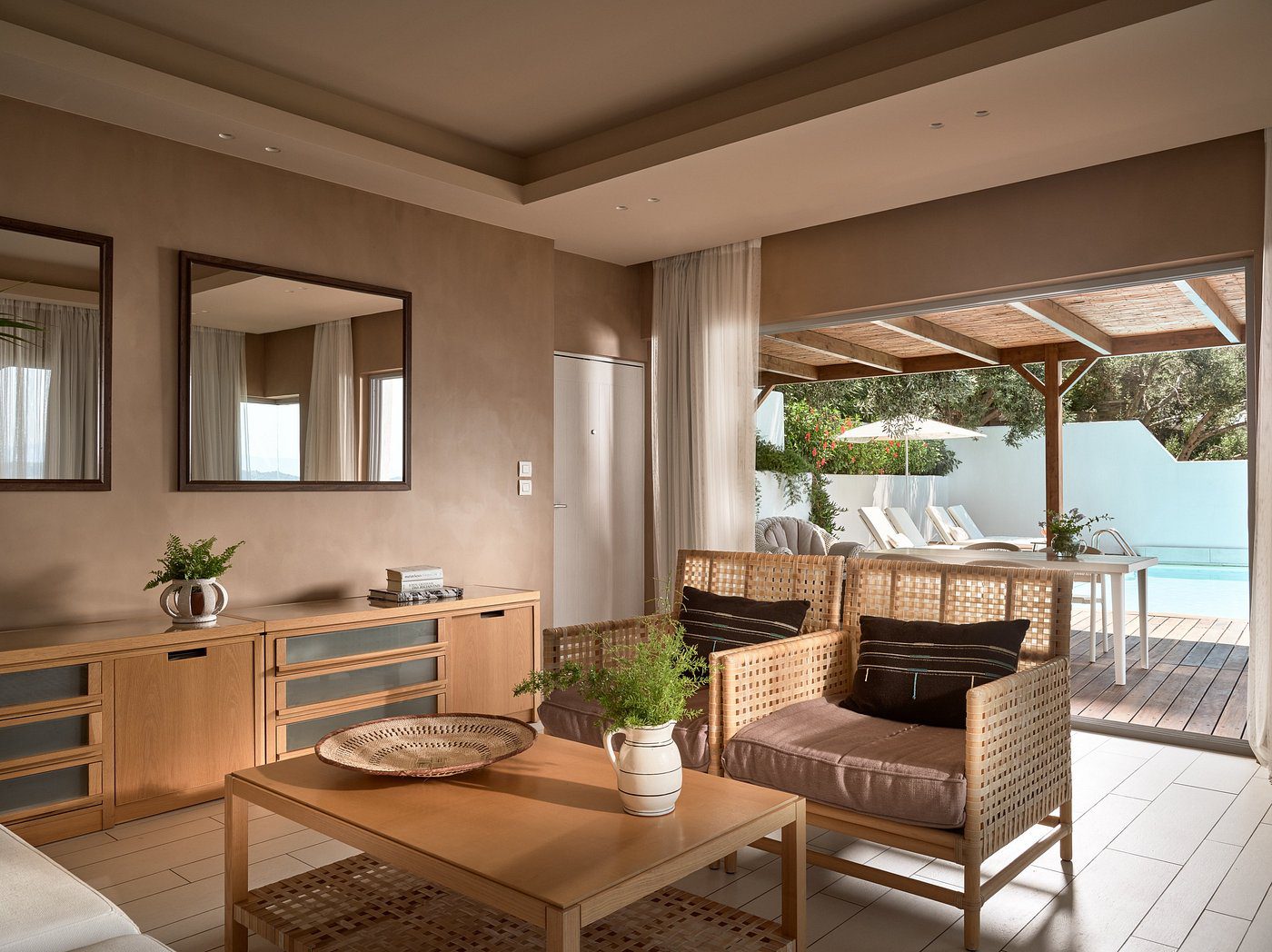 Cozy modern living room with natural decor and outdoor view.